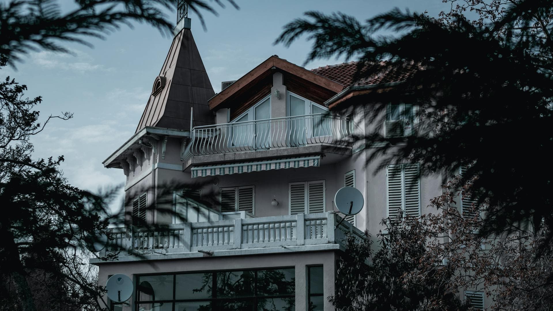 A large house with a satellite dish on the wall